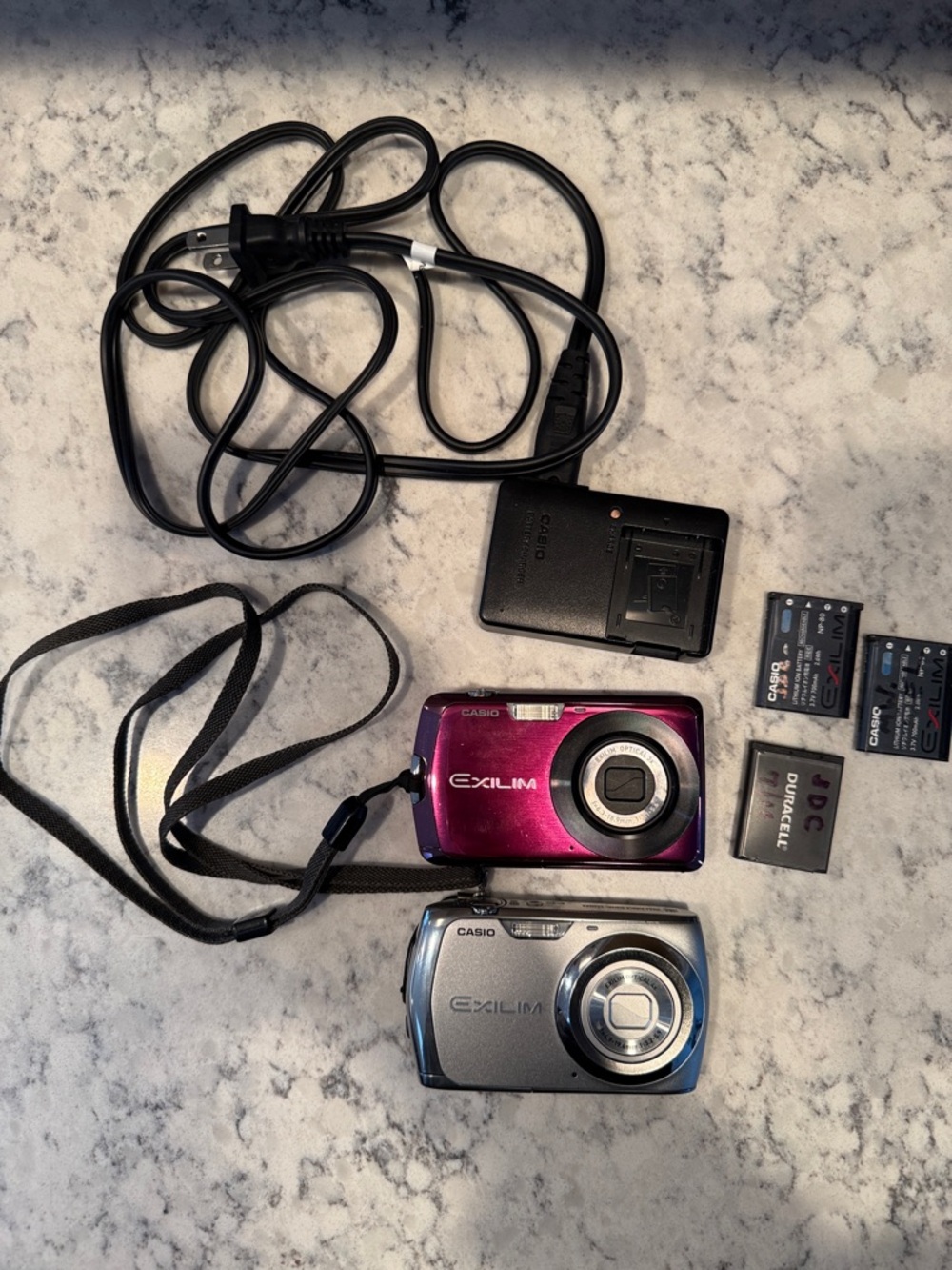 Set of two Casio Exilim Compact Digital Cameras - Pink & Silver with accessories